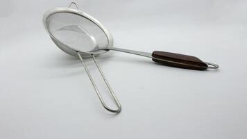3. Stainless spatula and strainer isolated photo