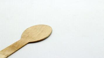 6. Wooden spoon and fork on white background photo