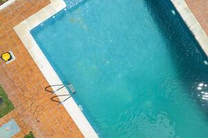 top-down aerial view of a rectangular swimming pool, aerial drone view. Concept of summer relax photo