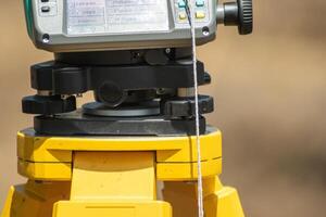 partial view of a total station, surveying machine detail view of surveying equipment on a tripod photo