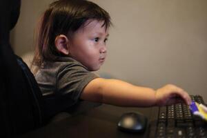 Boy Playing On Computer At Home, Background for advertising and wallpaper in education and work scene. photo