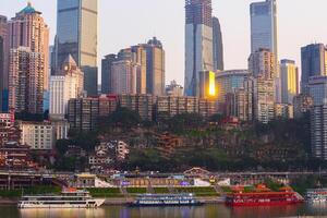 Chongqing, China-APR 02, 2025-Cityscape of the famous downtown shopping complex Hongyadong with illuminated bridge and highrise building in Chongqing, China photo