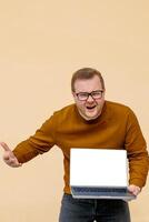A perplexed Caucasian male holds a blank laptop, embodying Cyber Monday chaos and the paradox of digital minimalism photo