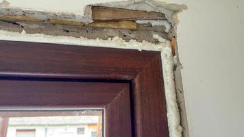 Damaged window frame repair in old house, DIY renovation, home improvement, construction maintenance, rustic architecture details photo