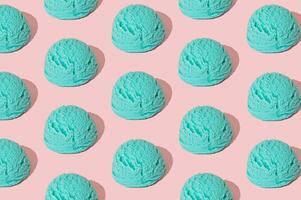 Blue ice cream pattern on pastel pink background. Summer food concept. Minimal isometric layout. Ice cream scoop aesthetic background idea. photo