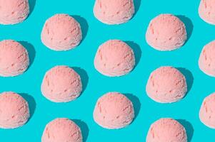 Pink strawberry ice cream pattern on light blue background. Summer food concept. Minimal isometric layout. Ice cream scoop aesthetic idea. photo