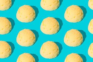 Vanilla ice cream pattern on pastel light blue background. Summer food concept. Minimal isometric layout. Ice cream scoop aesthetic idea. photo