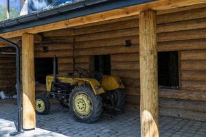 Tractor without a roof, a convertible on a plot near a residential building. Poland photo