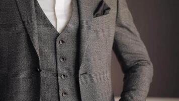 Buttoning jacket with hands close up, man in suit fastens buttons on his jacket preparing to go out video