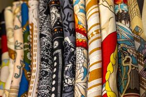 Vibrant textiles displayed in a market showcasing various patterns and colors in the afternoon light photo