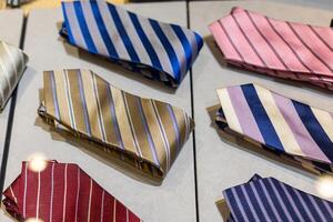 Display of vibrant ties showcasing various colors and patterns in a retail setting photo