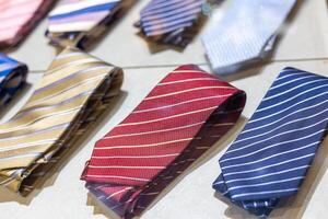 Display of assorted neckties showcasing modern styles and colors in a retail store during daylight photo