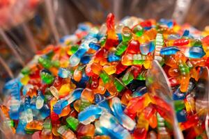 Colorful gummy candy displayed in a bowl at a festive event during the afternoon with a mix of assorted flavors and shapes photo
