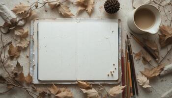 Creative Workspace With a Blank Notebook, Autumn Leaves, and Warm Coffee in a Cozy Setting photo