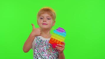 Stylish cute little child kid play with trendy pop it bubble squishy sensory toy game on chroma key video