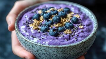 Creamy blueberry smoothie served in a bowl garnished with fresh blueberries for a refreshing and nutritious drink photo