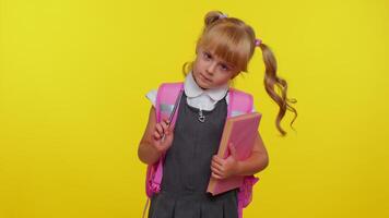 Smiling funny schoolgirl making humorous face with eyes crossed, playing fool, having fun, brainless video