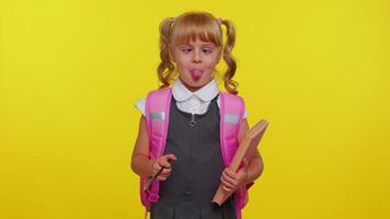 Smiling funny schoolgirl making humorous face with eyes crossed, playing fool, having fun, brainless video