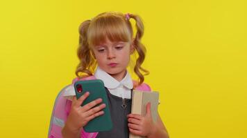 Girl kid in school uniform using mobile phone typing new post, sms message, browsing social networks video