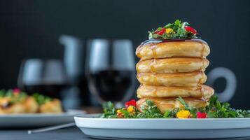 Towering stack of golden brown pancakes piled high on a white plate ready to be enjoyed with butter and syrup photo