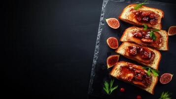 Delicious plate of toasted bread topped generously with fresh figs and accompanied by sliced figs for added flavor photo