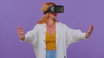 Girl using virtual reality futuristic technology VR headset helmet to play simulation 3D game video