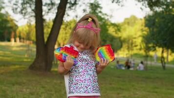 Child girl kid showing many colorful squishy silicone bubbles sensory toy, kid playing pop it game video