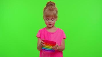 Child girl kid playing push pop it fidget toy and meditating, stress anxiety relief squeeze sensory video