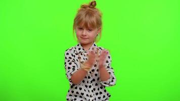 Happy cheerful kid child girl greatly approves your suggestion, shaking head approvely like proposal video