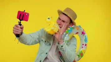 Man traveler blogger in sunglasses, taking selfie on mobile phone, communicating call online video