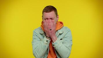 Upset disappointed man wipes tears and cries from despair, being sad because of unfair things video