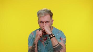 Aggressive tourist man trying to fight at camera, shaking fist, boxing with expression, punishment video