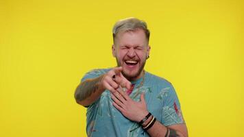 Man pointing finger to camera, laughing out loud, making fun of ridiculous appearance, funny joke video