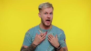 Man on yellow studio background pointing fingers himself ask say who me no thanks I do not need it video