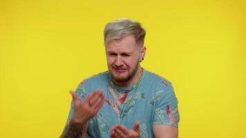 Upset man cries, raising hands in indignant expression asking why what reason of failure irritation video