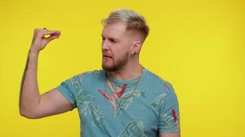 Tired irritated tourist man showing nonsense gesture with hands, gossips, empty promises, blah, lier video