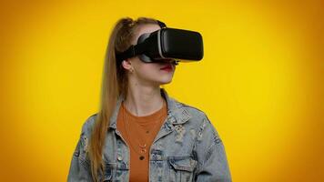 Girl using virtual reality futuristic technology VR headset helmet to play simulation 3D game video