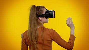 Girl using virtual reality futuristic technology VR headset helmet to play simulation 3D game video