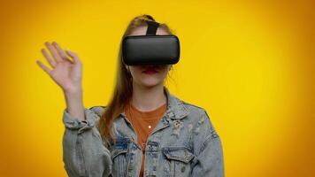 Girl using virtual reality futuristic technology VR headset helmet to play simulation 3D game video