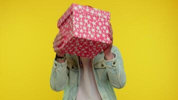 Young man unwrapping birthday gift and expressing disappointment, dislike bad present, dissatisfied video