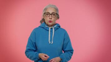 Elderly woman raising hands in indignant expression, asking why, what reason of failure, irritation video