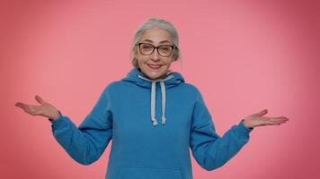Elderly woman raising hands in indignant expression, asking why, what reason of failure, irritation video