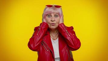 Dont want to hear and listen, irritated elderly woman covering ears, gesturing no, avoiding advice video