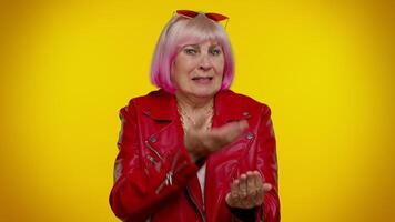 Senior woman raising hands in indignant expression, asking why, what reason of failure, irritation video