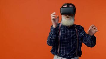 Senior man using virtual reality VR app headset helmet to play simulation 3d 360 game, drawing video