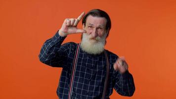 Elderly bearded man showing loser gesture and pointing on you, blaming accusing for unsuccess fail video