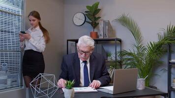 Senior man boss freelancer concentrated developing new project while analysis financial graph data video