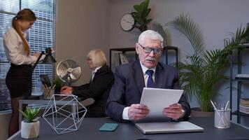 Senior man boss dissatisfied with bad results of work reviewing report and documents with errors video
