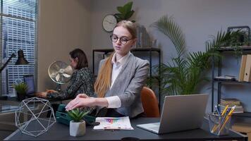 Portrait of business woman looking camera doing gesture call me back with retro telephone at office video