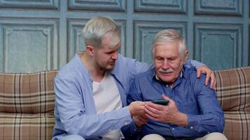 Different male generations family resting, using mobile applications, shopping in online store video